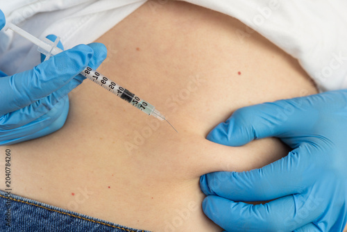 ghk cu peptide injection subcutaneous belly fold syringe hands analog ingredients therapy close up view looking away concept of cosmetology, biochemistry, pharmacology