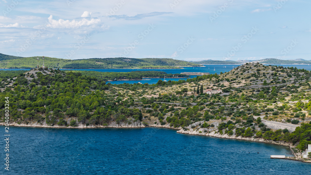 Fototapeta premium Scenic aerial view of the Adriatic Sea coastline with green islands and blue water in Croatia