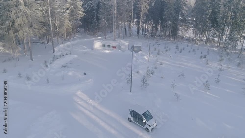 Aerial drone following car in winter