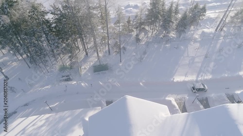 Aerial sideways drone following car in snow