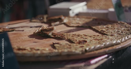 Traditional savory pastry slices displayed on a wooden board at Kvatric Market in Zagreb Croatia.