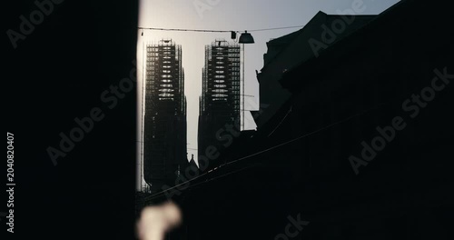 Zagreb Cathedral towers under reconstruction silhouetted against sunset light in Zagreb Croatia.
