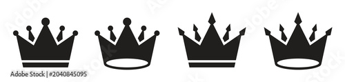 Foto Four black crown silhouettes with varying designs on a white background
