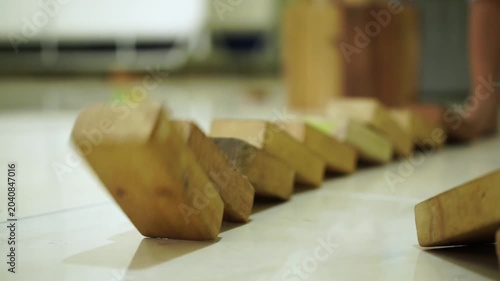 Wooden domino blocks falling in motion video sequence showing reaction