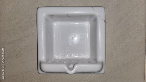 Εκτύπωση καμβά White ceramic sink mounted on beige tiled wall