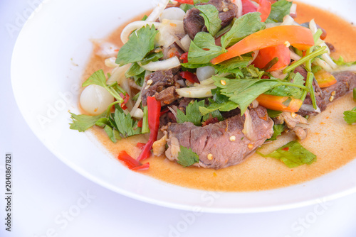 Spicy thai beef salad with fresh herbs and vegetables.