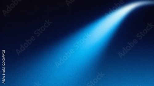 A bright blue light beam shining on a dark blue background with texture
