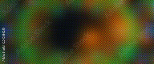 Abstract blurred background with soft green and orange light, dark atmospheric bokeh texture, colorful out of focus glow