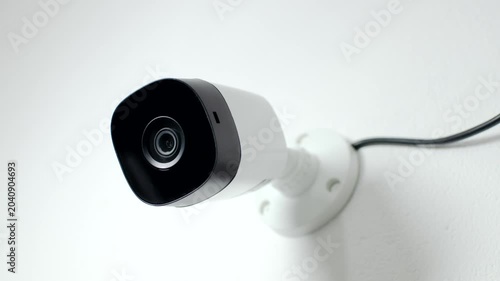 Effective Surveillance: CCTV security camera mounted on a white wall, ensuring protection and continuous monitoring.