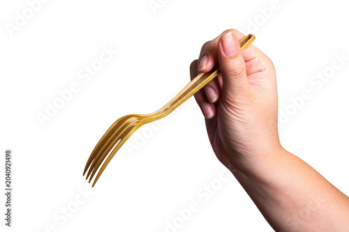 Female hand holding a gold plastic fork isolated on white background.