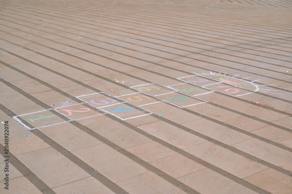 Fototapeta premium Colorful Hopscotch Game Drawn with Chalk on a Paved Outdoor Surface