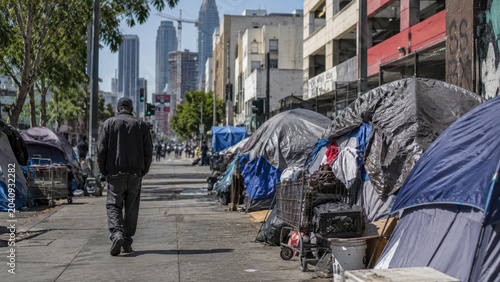 Homeless encampment on a city street. Social inequality, housing crisis, poverty and urban challenges in a modern metropolitan environment.