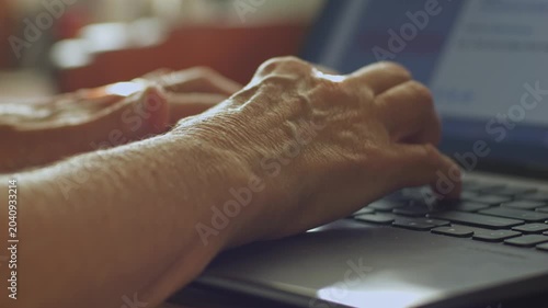 A woman types a comment on a laptop and posts it on social media
