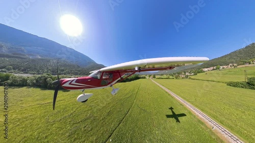 POV light aircraft landing on a mountain field, french alps