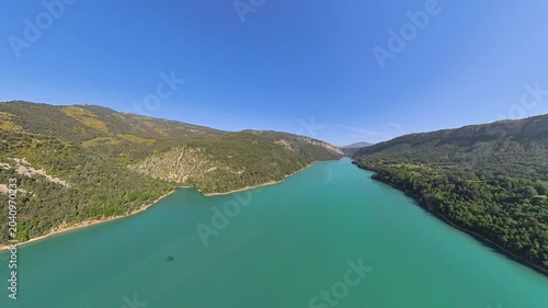 pilot view, Aerial low altitude flight over Lake Castillon with Alpine mountain reflections on calm water, Provence, France