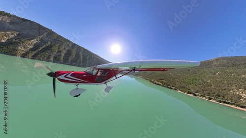 External airplane view flying at low altitude over Alpine Lake and mountains, Southern France