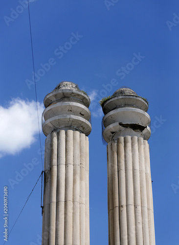 Photography Two old stone fluted columns against blue sky