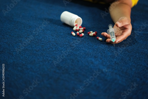 Tableau sur toile A photo of a desperate young drug addict lying on the floor