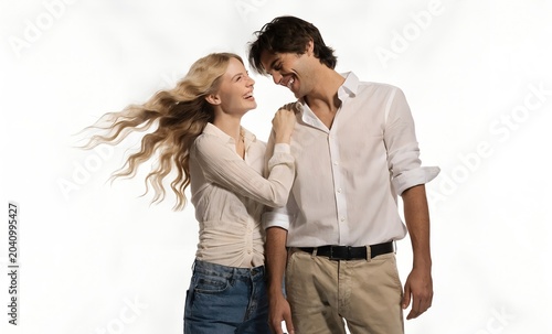 Happy couple laughing together in casual white clothing on white background