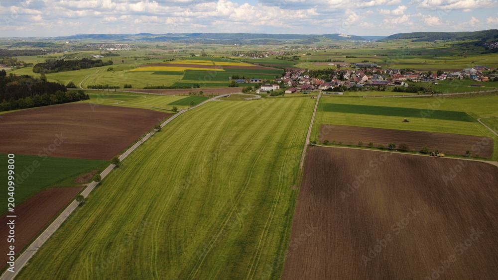 Naklejka premium Aerial drone view of colorful farmland fields and rural countryside