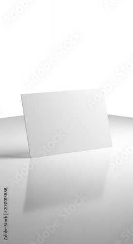 Blank White Business Card on Reflective Surface with Copy Space.