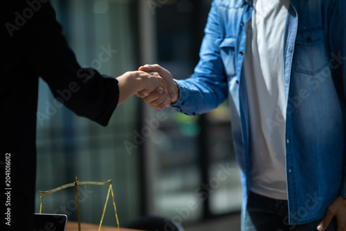 Handshake after good deal, Hispanic man handshake male lawyer after discussing good deal , Meeting and greeting. Legal law, advice and justice. woman lawyer showing papers to client in office.