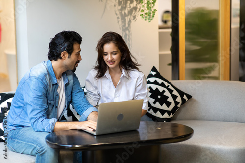 Happy young family couple shopping online with laptop computer. making purchases online concept.