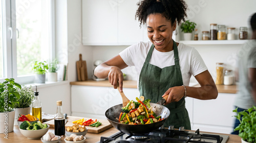 African American woman cooking healthy stir-fry in modern kitchen with natural lighting for food blog