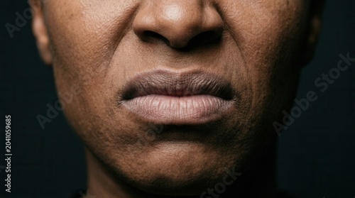 Close-Up Shot Of An Expression Of Disgust On A Dark-Skinned Person's Face