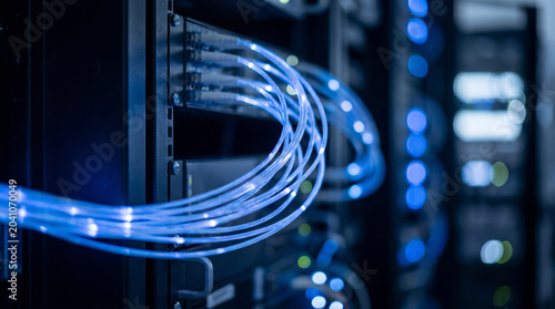 Tableau sur toile Close-Up Of Glowing Blue Fiber Optic Cables In A Server Room With Bokeh Lights