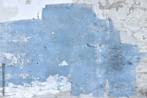 messy blue colours stains and paint brush stroke smears on grunge wall texture, abstract background