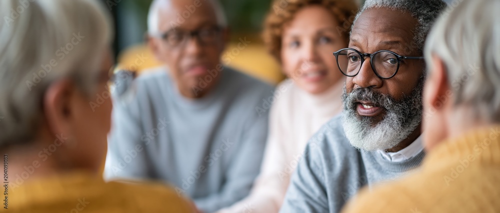Fototapeta premium A thoughtful group of elderly individuals engages in lively conversation, showcasing the importance of connection and community in a warm and inviting environment.