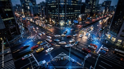 Evening Cityscape Captures Bustling Urban Traffic at Illuminated Intersection