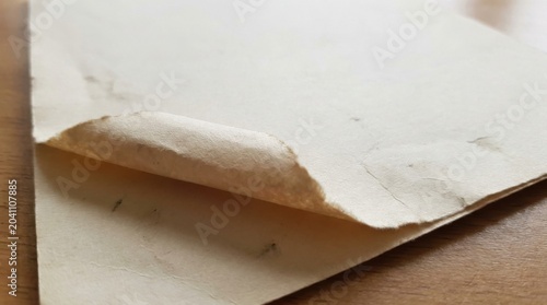 Torn Paper Edge Close-Up on Wooden Surface for Artistic and Office Use