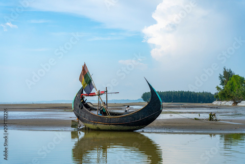 Obraz na płótnie Traditional wooden fishing boat on the beautiful Inani Sea Beach in Ukhia Upazila of Cox’s Bazar District, Bangladesh