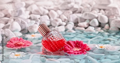 Red perfume on the shore of sea with ​​white stones. 