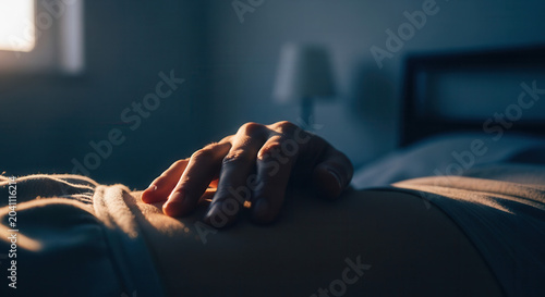 Gentle Touch: Hand Resting on Abdomen, Bathed in Soft Evening Sunlight