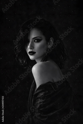 A dark atmospheric portrait with gothic aesthetics. The subject is surrounded by shadows, gray tones, and mysterious light, creating a surreal and artistic mood. Perfect for fantasy, gothic, or creati