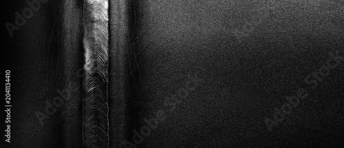Konstfotografi A neat weld seam on a metal pipe, made with an automatic welding machine