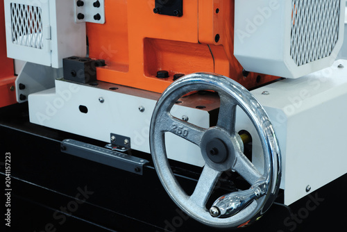 Картината върху платно Close-up metal wheel spins on industrial machinery