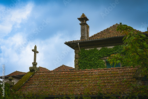 Historic Stone Cross and Traditional Rooftops in Rural Portugal,