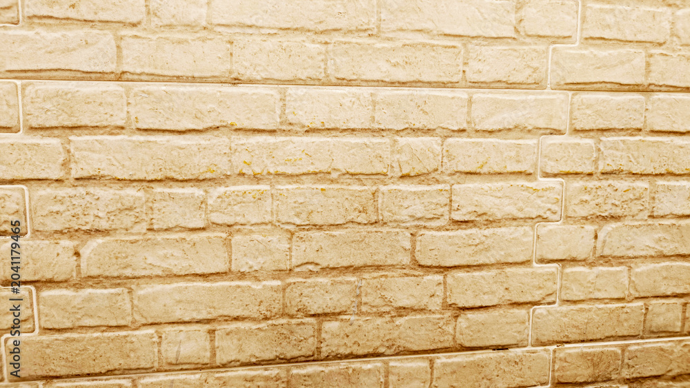 Fototapeta premium Light beige brick wall texture background, decorative masonry surface with rustic pattern suitable for construction and design projects.