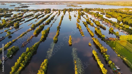 Aerial drone view the harbour of Scheendijk Loosdrechtse Plassen, a floating village in the Netherlands at sunset. High quality 4k footage