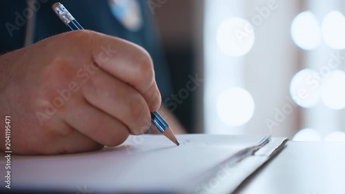 Black paramedic writing ambulance report, urgent blue lights bokeh, clipboard on gurney, pen filling incident form, documenting vitals and treatments, siren hum in background, crew coordination, rapid