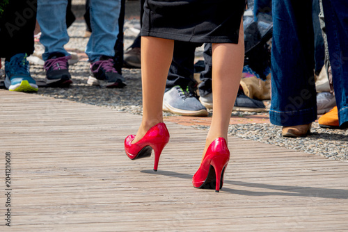 Woman strides confidently in red heels