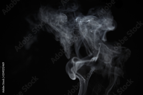 White natural wave smoke abstract texture on black background with copy space. Aroma incense smoke shape curve smooth backdrop