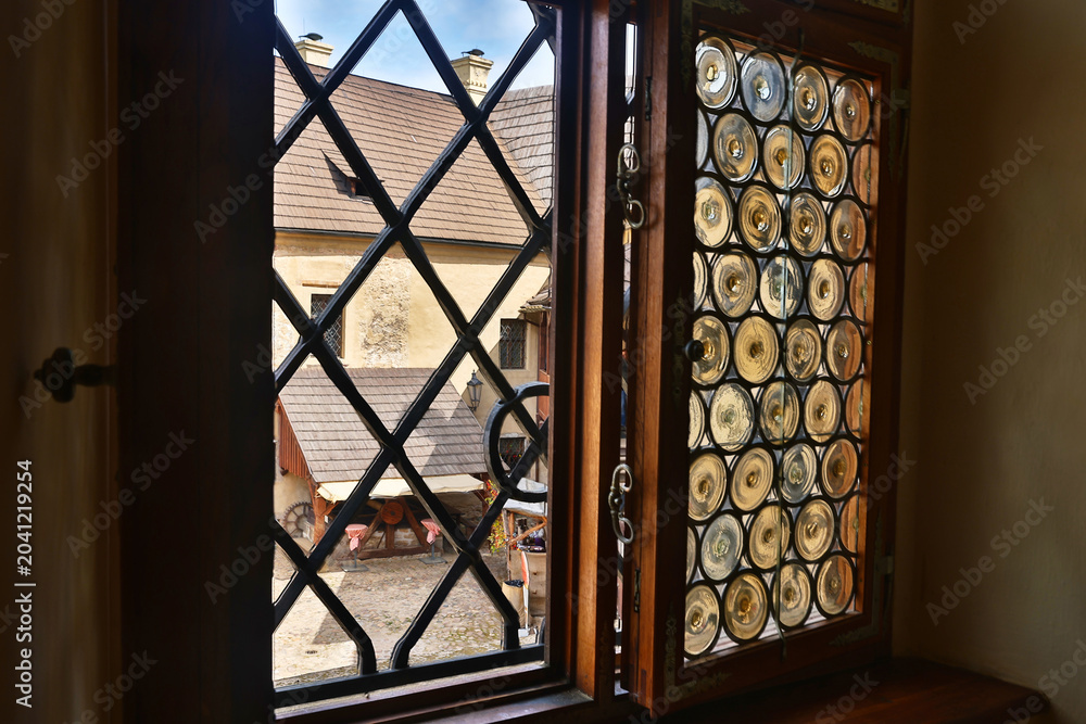 Obraz premium View from an ancient castle window to a medieval courtyard.