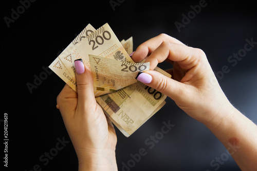 The woman counts the money. Poland. Polish zloty.