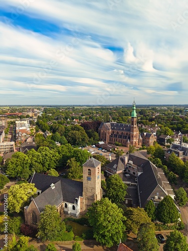 Drone View of Dutch Town (Lisse) with Church, Trees and Expansive Sky