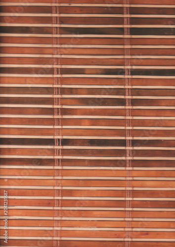 Wooden palette with dark wood slats, used as a window blind